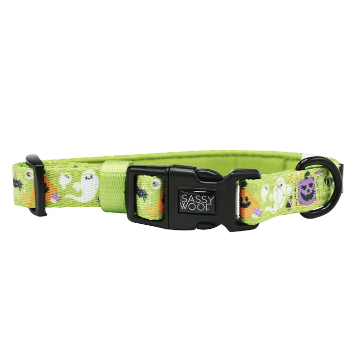 The Sassy Woof Dog Collar - Haunt Mess is a green adjustable collar with a sturdy plastic buckle, playful cartoon ghosts, Halloween-themed designs, and a strong D-ring for secure leash attachment.