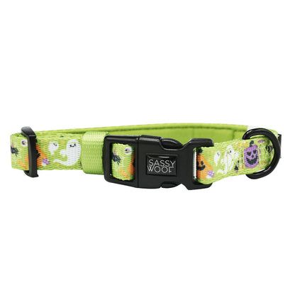 The Sassy Woof Dog Collar - Haunt Mess is a green adjustable collar with a sturdy plastic buckle, playful cartoon ghosts, Halloween-themed designs, and a strong D-ring for secure leash attachment.