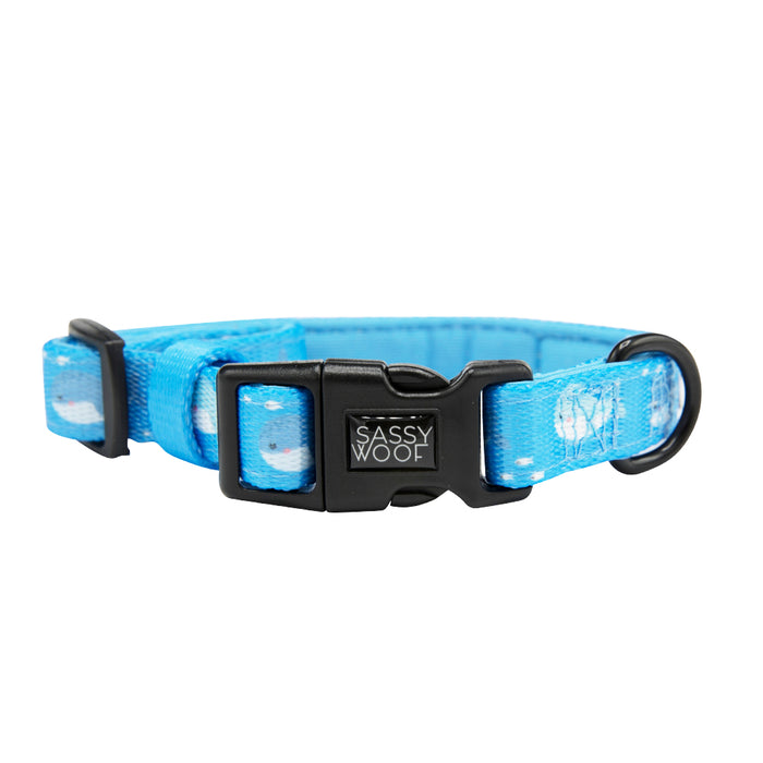 The Sassy Woof Dog Collar – Might as Whale features blue and white cloud patterns, a black plastic buckle, and sturdy D-ring—perfect for pairing with a matching reversible or neoprene dog harness.