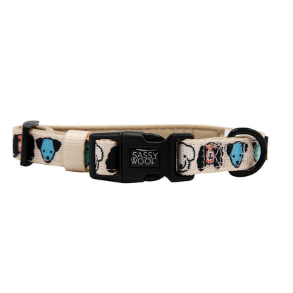 The Sassy Woof Dog Collar - Mixed With Love features a beige adjustable strap, black plastic buckle, sturdy D-ring, and a blue and black cartoon dog face pattern.