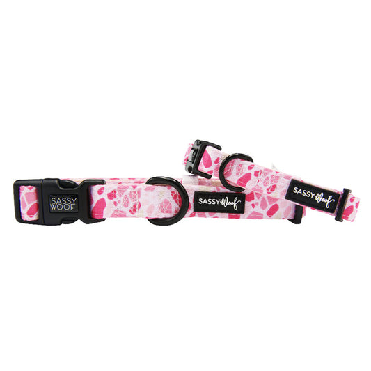 The Sassy Woof Dog Collar - Mykonos features pink neoprene and black buckles, offering adjustable comfort and style—perfect for pups looking for a chic Mykonos-inspired accessory.
