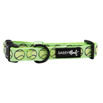 The Dog Collar - Serving Up Sass by Sassy Woof is a green adjustable dog collar with black hardware, decorated with tennis balls and finished with a black Sassy Woof label in white text.
