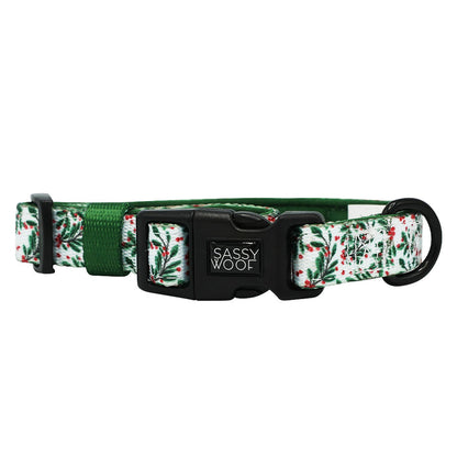 The Dog Collar - Under the Mistletoe by Sassy Woof features a green and white holly pattern, adjustable green strap, and black Sassy Woof buckle—perfect for pairing with matching dog accessories.