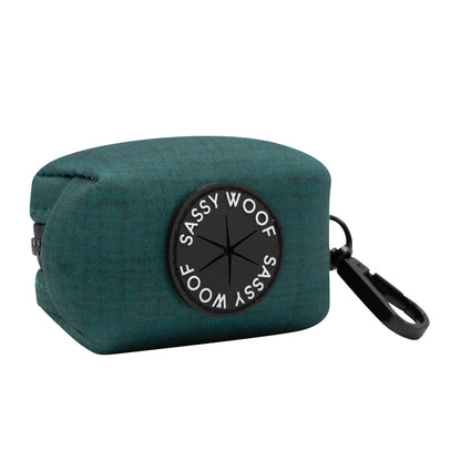 Add a pop of teal to your walks with this Sassy Woof fabric dog waste bag holder, featuring the black Sassy Woof logo on the front, a convenient side zipper, and a sturdy black clip for easy attachment to your dog’s collar, leash, or bag—an ideal match for your Dog Collar Three Piece Bundle - Forest from Sassy Woof.