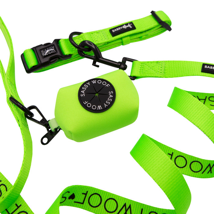 Introducing the Sassy Woof Dog Collar Three Piece Bundle in Neon Green—a bold and stylish set featuring a bright green leash with matching waste bag holder attached to the leash clip. This vibrant bundle pairs perfectly with any neon dog collar and is finished with durable plastic buckles and sleek black metal hardware, making it an essential addition to your neon dog accessories collection.