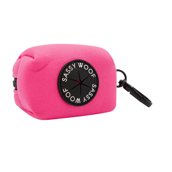 Carry your dog’s waste bags in style with this bright pink, rectangular bag holder from Sassy Woof, featuring a black circular logo on the side and a sturdy black plastic clip for attaching to your leash or bag. For the perfect matching look on walks, pair it with the Dog Collar Three Piece Bundle - Neon Pink by Sassy Woof.