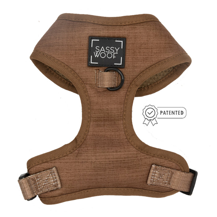 The Sassy Woof Dog Four Piece Bundle - Teddy features a brown adjustable harness with black trim, SASSY WOOF label, black metal ring, and patented icon on the right.
