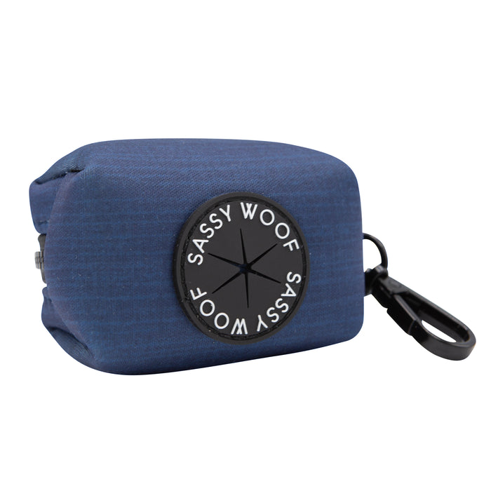 A blue fabric pouch with a black clip and round Sassy Woof label from the Dog Four Piece Bundle - Twilight is perfect for holding small items like waste bags during walks with your adjustable harness.