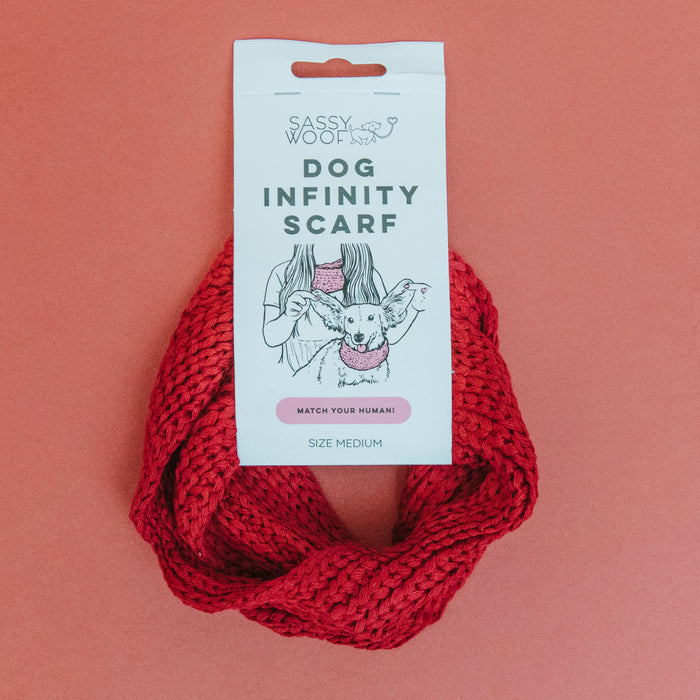 The Sassy Woof Dog Infinity Scarf - Red comes in packaging showing a dog wearing the scarf and states "Match your human!" Size Medium is indicated, making it perfect for cold weather walks.