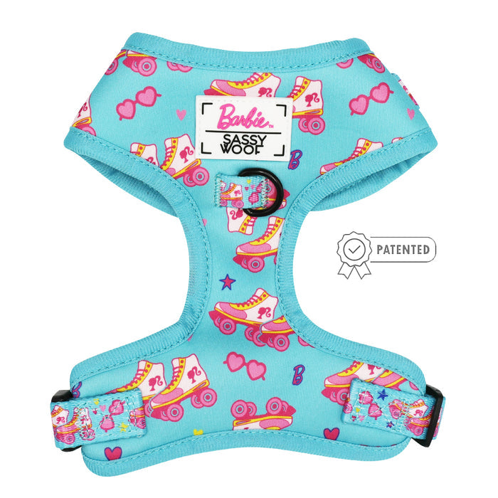 The Sassy Woof Dog Two Piece Bundle - BARBIE™ On a Roll features a turquoise harness with colorful roller skates, hearts, sunglasses, and logos—plus a patented badge for pups on a growth pawtection plan!.