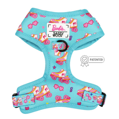 The Sassy Woof Dog Two Piece Bundle - BARBIE™ On a Roll features a turquoise harness with colorful roller skates, hearts, sunglasses, and logos—plus a patented badge for pups on a growth pawtection plan!.