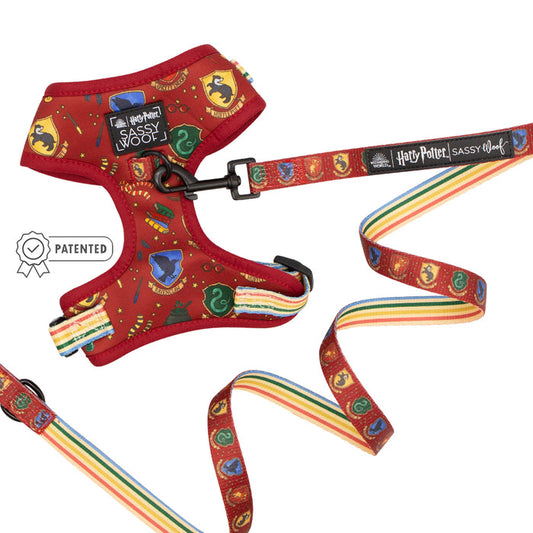 The Sassy Woof Dog Two Piece Bundle - Harry Potter™ includes a red adjustable harness and leash with colorful house crests, symbols, and rainbow stripes—a magical addition to any Harry Potter dog harness collection. Features patented icon near the harness.