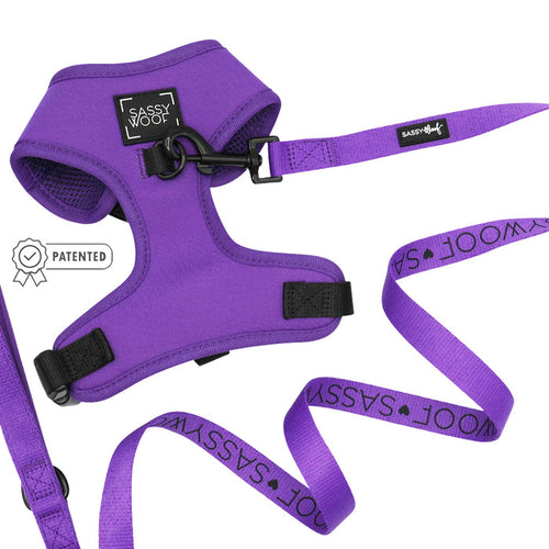 The Sassy Woof Dog Two Piece Bundle in Neon Purple offers a stylish, adjustable harness and leash set—ideal for comfort and a secure fit as your dog grows.