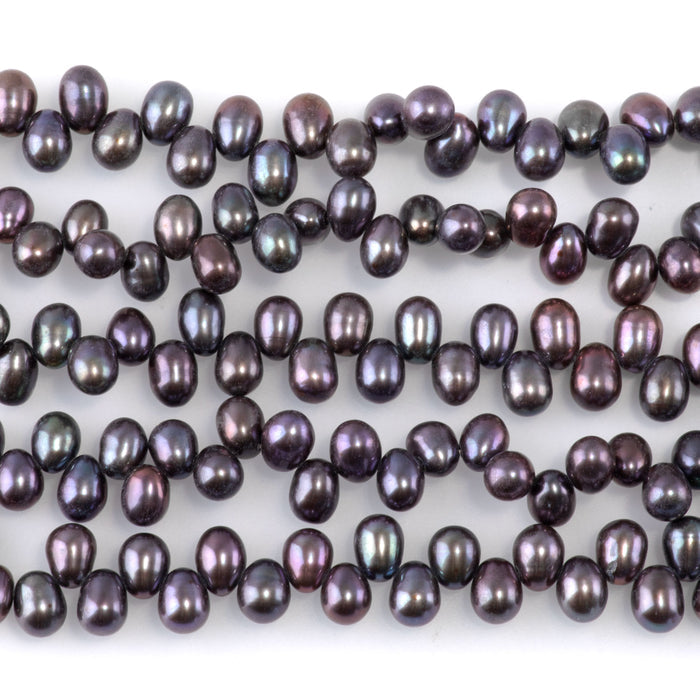 This is a Dakota Stones 5mm Freshwater Pearl Peacock Rice Gemstone strand of round beads.