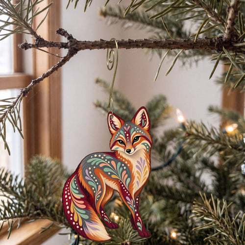 Laser-cut maple wood Gray Fox folk art ornament O254 hanging on a fir branch, made in USA
