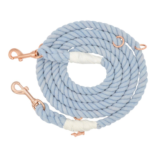 Introducing the Sassy Woof Hands-Free Rope Leash - Azul: a hand-crafted, coiled light blue leash featuring rose gold metal clips and rings at each end, reinforced with white tape for added durability.