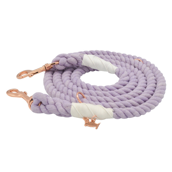 The Sassy Woof Hands-Free Rope Leash in Lavender features rose gold metal clasps and reinforced sections wrapped with white tape, and is shown coiled on a white background.