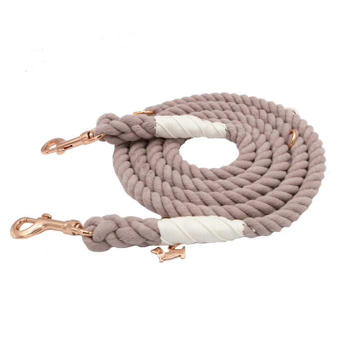 Introducing the Hands-Free Rope Leash - Le Café by Sassy Woof: this hand-crafted rope dog leash in coiled beige features rose gold metal clips at both ends and is reinforced with white tape wrapping for added durability.