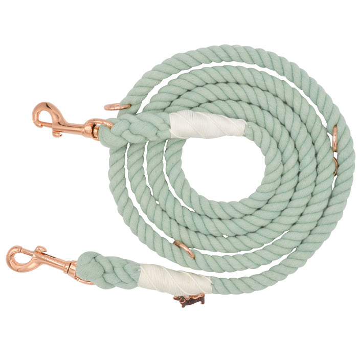 Introducing the Hands-Free Rope Leash - Mint to Be by Sassy Woof: a hand-crafted mint green dog leash designed in a coiled rope style, accented with rose gold metal clasps at both ends and wrapped with white tape near each clasp.