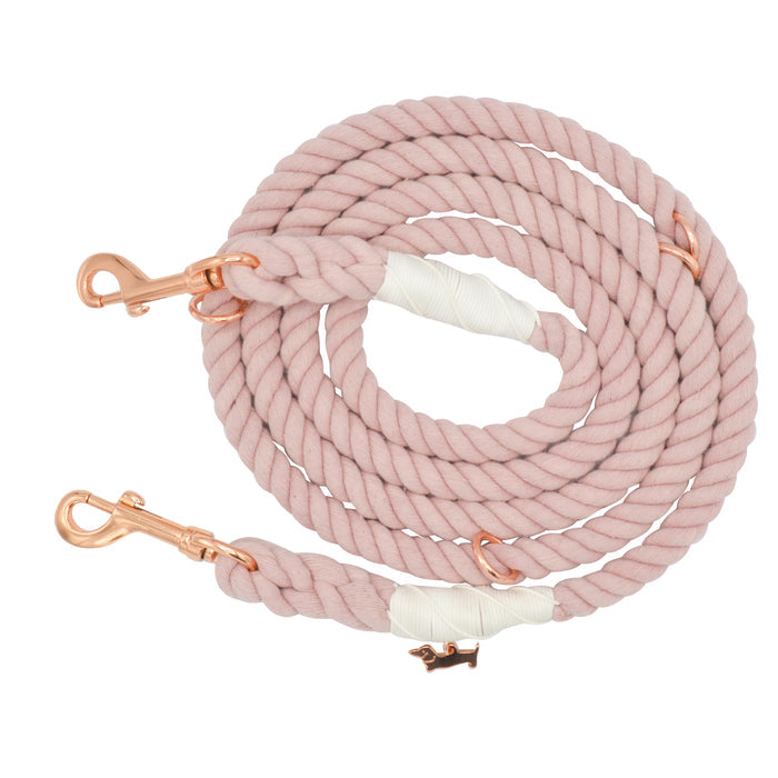 Introducing the Sassy Woof Hands-Free Rope Leash - Rose All Day: a beautifully hand-crafted, coiled light pink leash featuring rose gold metal clips at both ends and elegant white wrapped accents.
