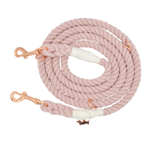 Introducing the Sassy Woof Hands-Free Rope Leash - Rose All Day: a beautifully hand-crafted, coiled light pink leash featuring rose gold metal clips at both ends and elegant white wrapped accents.