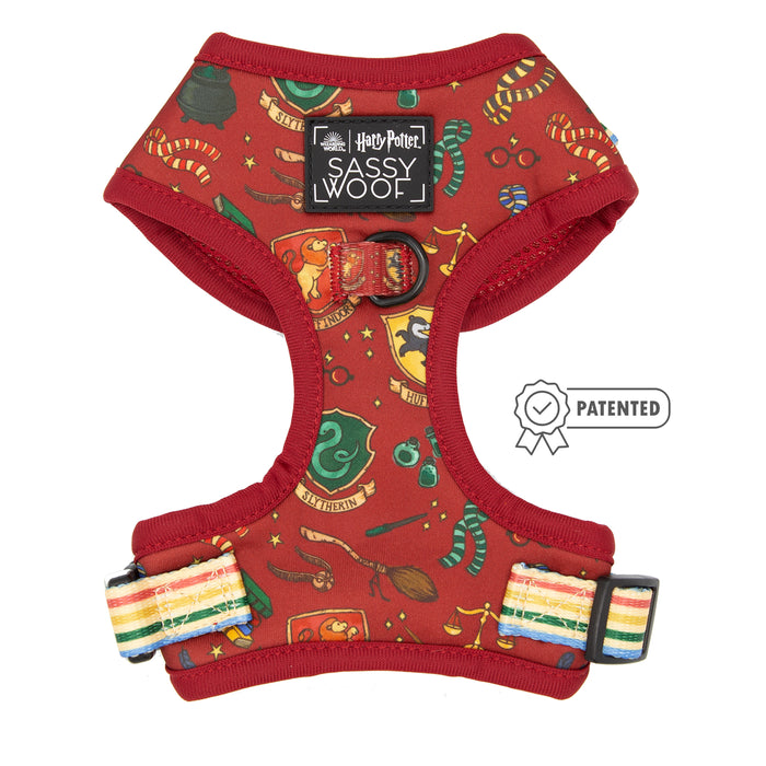 The Harness Three Piece Bundle - Harry Potter™ by Sassy Woof features a red harness with colorful house crests, rainbow-striped adjustable straps, a patented symbol, and black label—pairs perfectly with the matching Harry Potter dog collar.