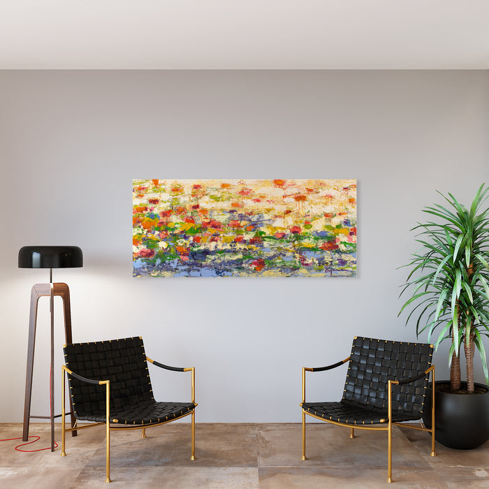 The artwork 'Island of Allurement' by Ayane Kurai features a vibrant abstract landscape painting with impressionistic wildflowers in orange, yellow, blue, and red hues spreading across a horizontal canvas. The composition suggests a meadow or garden with textured brushstrokes creating depth and movement, set against a soft peach-colored sky. Oil on canvas, 30x68 inches.