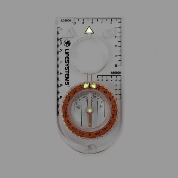 Lifesystems Hiking Compass in dim light showcasing the luminous markings on a white background