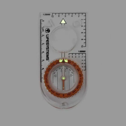 Lifesystems Hiking Compass in dim light showcasing the luminous markings on a white background