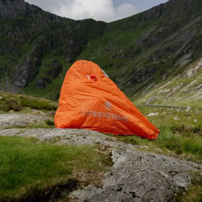 Lifesystems Survival Shelter 1 Man set-up with a mountainous landscape in the background