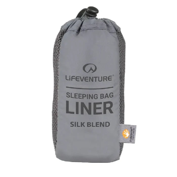 Lifeventure Silk Blend Sleeping Bag Liner in its stuff sack on a white background