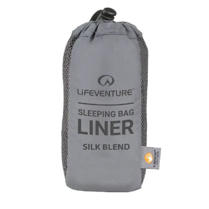 Lifeventure Silk Blend Sleeping Bag Liner in its stuff sack on a white background