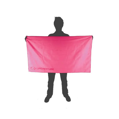 Pictorial image showing the relative size of a Lifeventure SoftFibre travel towel in xlarge pink in comparison to a person