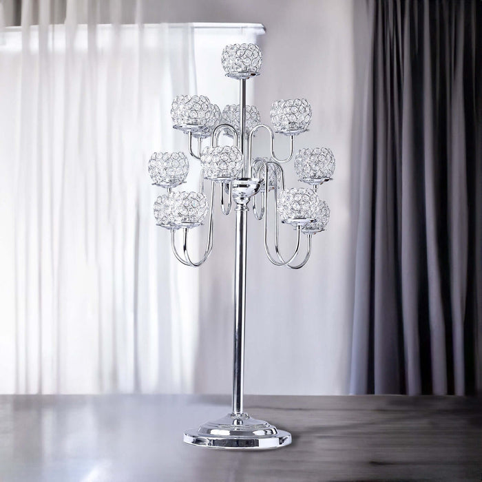 Elegant chrome candle holder with crystal globes, perfect for home decor.