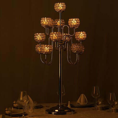 Elegant metal candelabra with decorative candle holders, glowing softly.