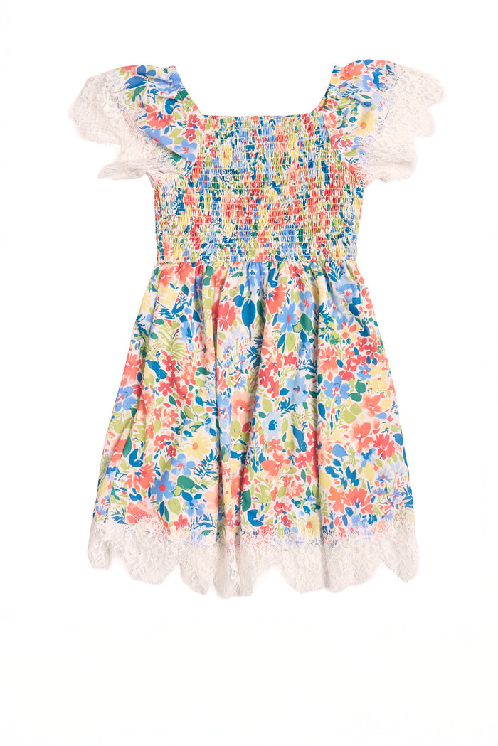 The Mini Ada Dress in Vibrant Yarrow Print by Ivy City Co is a cheerful floral spring dress for kids, featuring short flutter sleeves, a smocked bodice, and white lace trim on the sleeves and hem.