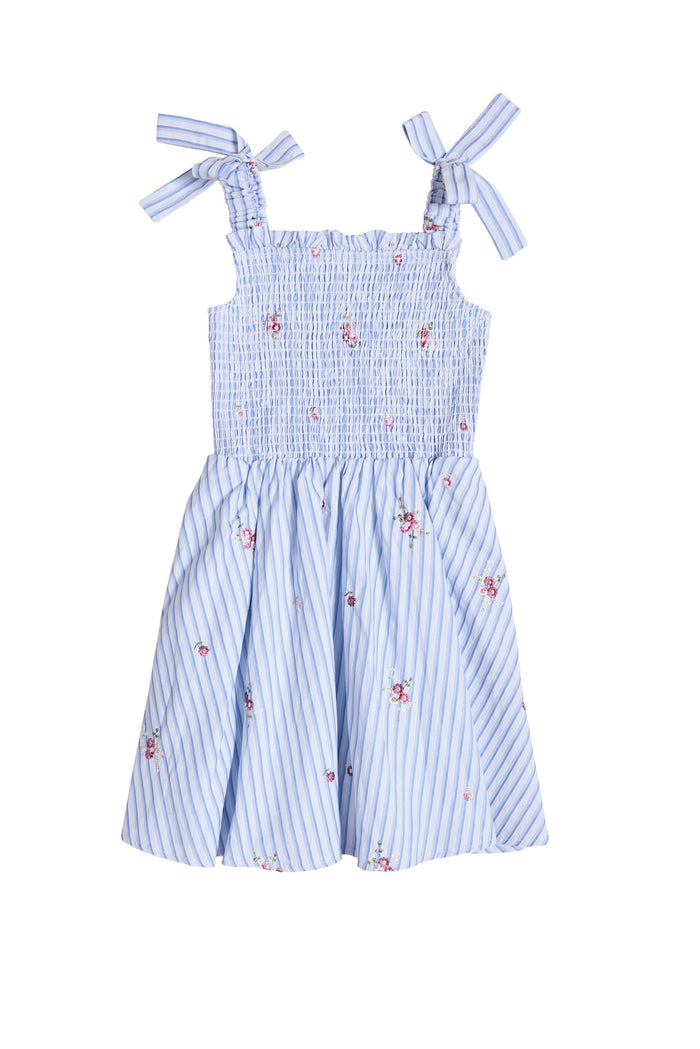 The Ivy City Co Mini Bluebell Dress in Blue & White Stripes features shoulder bows, pink floral accents, a smocked bodice, and a flared skirt for a summery, feminine look.
