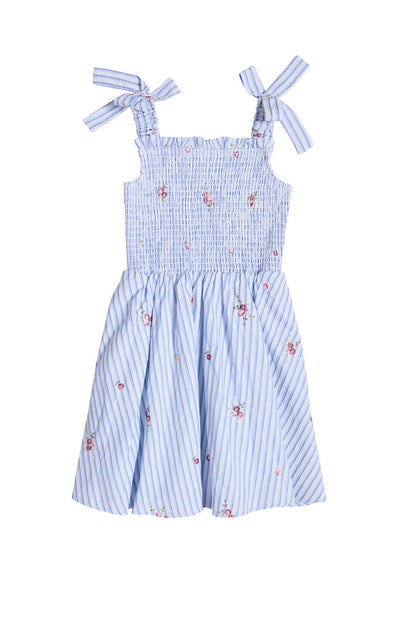 The Ivy City Co Mini Bluebell Dress in Blue & White Stripes features shoulder bows, pink floral accents, a smocked bodice, and a flared skirt for a summery, feminine look.