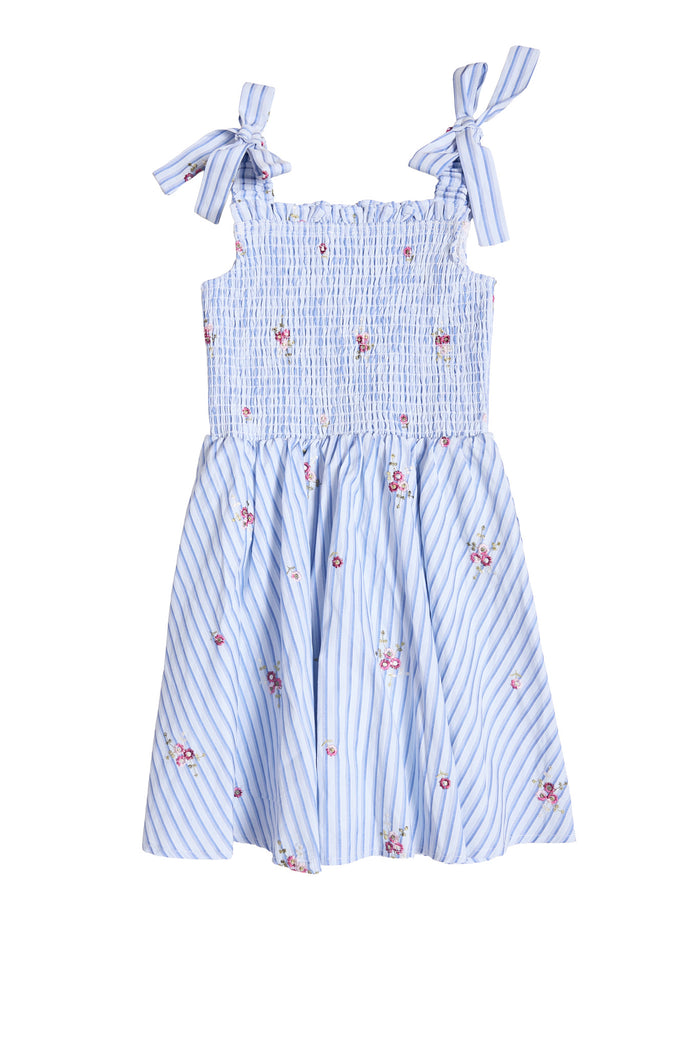 Ivy City Co Mini Bluebell Dress in blue & white stripes features small pink floral prints, a smocked bodice, and bow tie shoulder straps.