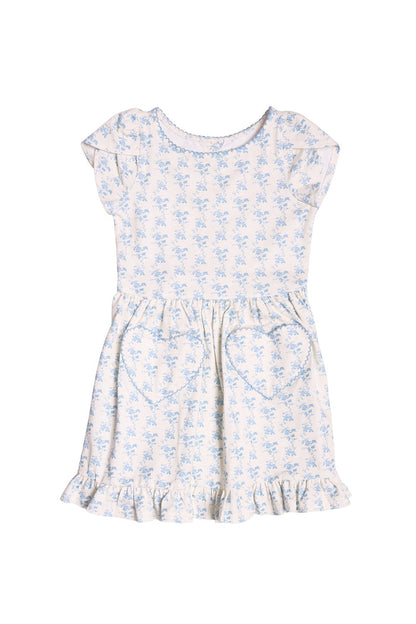 The Mini Dream Play Dress in Ivory Porcelain Fleur by Ivy City Co is a short-sleeved girls’ cotton dress with blue floral prints, heart front pockets, and a ruffled hem—perfect for playtime and shown on a white background.