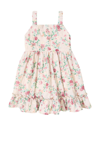 The Mini Helene Dress in Vibrant Chintz by Ivy City Co is a sleeveless cream girls’ dress featuring pink and green floral chintz, wide straps, a gathered waist, and a ruffled hem.