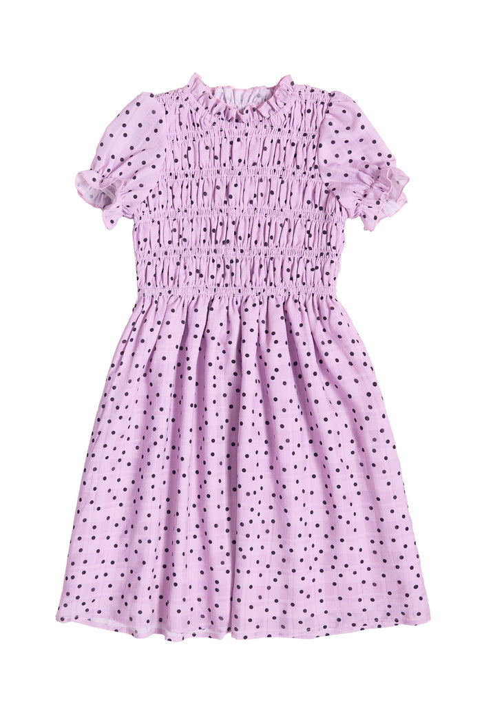The front of a Girls purple dress with black polka dots against a white background