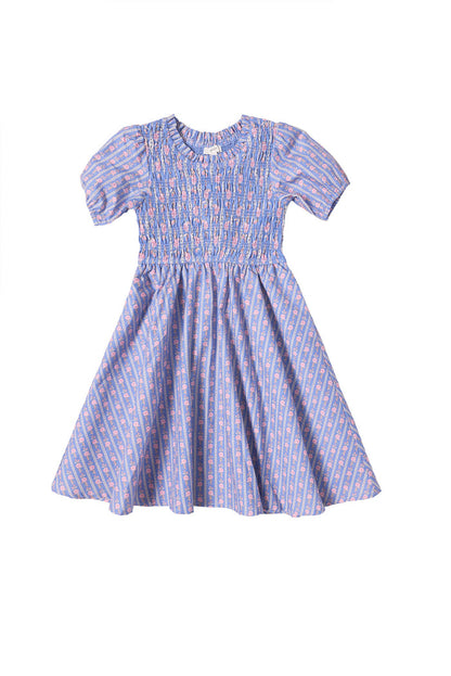 The Mini Mariah Dress in Linear Print by Ivy City Co is a purple, short-sleeved girls midi dress, featuring a smocked bodice and flared skirt with pink and blue floral cotton patterns. Displayed on a white background.
