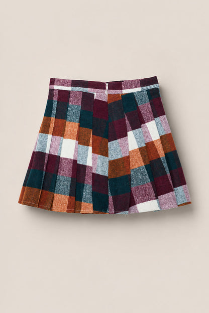 The Mini Marren Skirt in Maize Brushed Gingham by Ivy City Co features a pleated design and a bold checkered pattern in burgundy, orange, green, white, and gray hues. Crafted from soft wool-blend fabric, the skirt is displayed against a plain beige background.