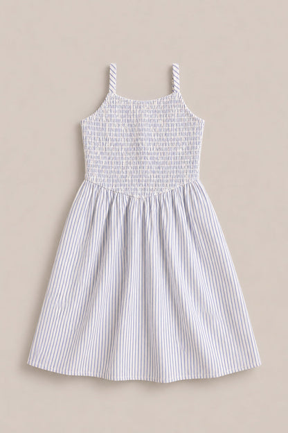 The Mini Maxwell Dress in Blue & White Pinstripe by Ivy City Co features a sleeveless design, smocked bodice, flared skirt, and thin blue stripes—ideal for stylish Mom and Me matching outfits.