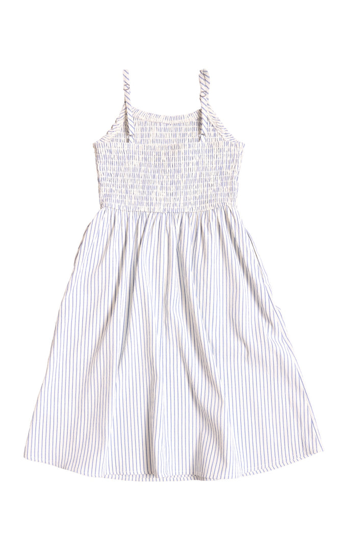 The Mini Maxwell Dress in Blue & White Pinstripe by Ivy City Co features a white sleeveless design with thin straps, light blue vertical stripes, a smocked bodice, and a flowing knee-length skirt—ideal for matching Mom and Me outfits.
