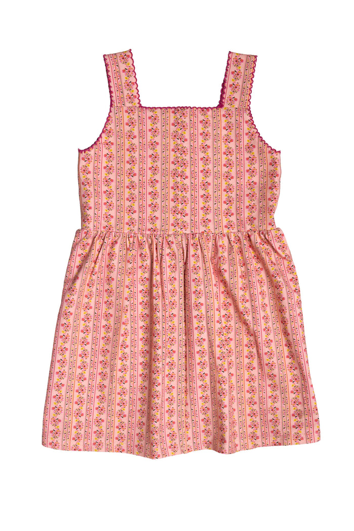 The Mini Rue Play Dress in Handpainted Flora Stripe by Ivy City Co is a sleeveless girls' dress with wide straps, a gathered waist, and decorative trim at the neckline—perfect for sunny day play.