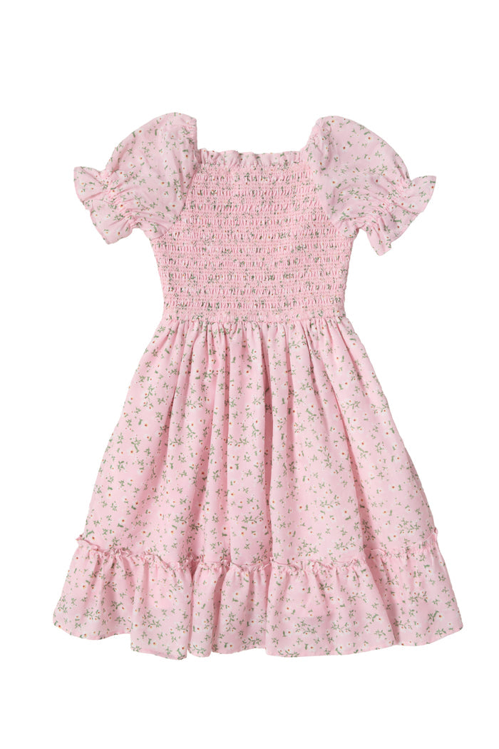 The Mini Valencia Dress in Pink Ditsy Floral by Ivy City Co is a girls' midi dress with short sleeves, a smocked bodice, ruffled hem, and charming green floral print shown laid flat on a white background.