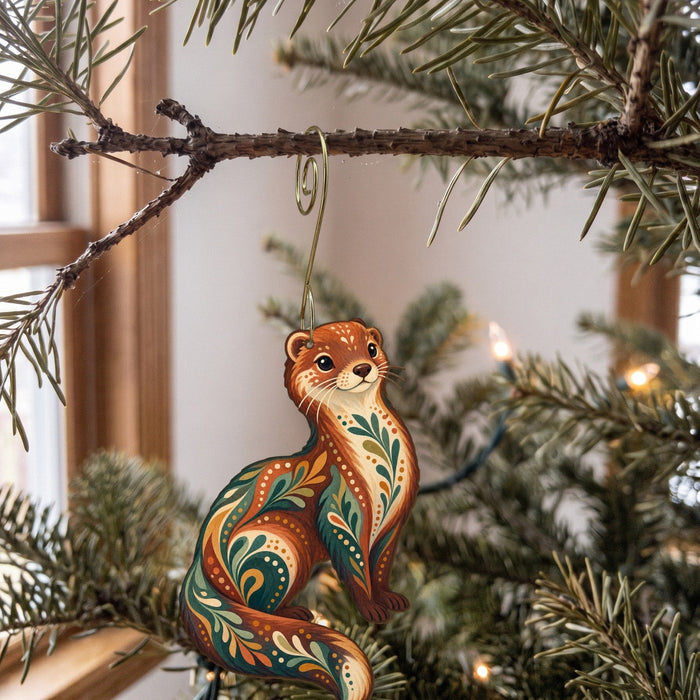 Laser-cut maple wood Mink folk art ornament O267 hanging on a fir branch, made in USA