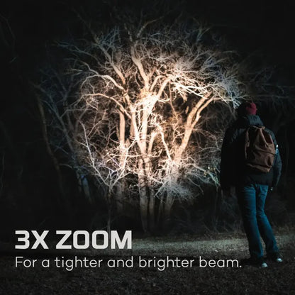 Person standing in front of a tree with a bright light effect, text indicating 3x zoom feature of the Nebo Davinci 3500 LED torch.